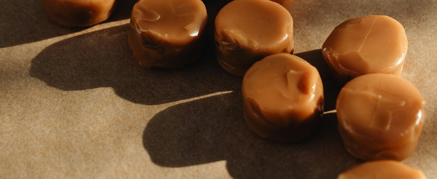 Close-up of caramel candies on a textured surface